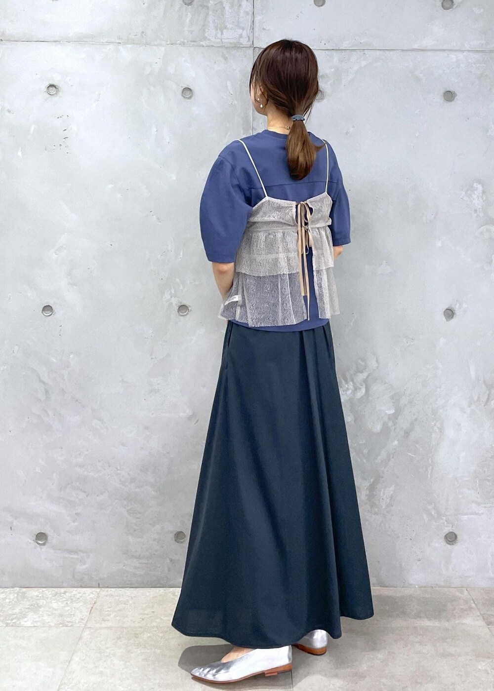 ホワイト系のハンドバッグ、ブルー系のTシャツ/カットソー、ブラウン系のキャミソールを着用したレディースの春コーディネートの5枚目の写真