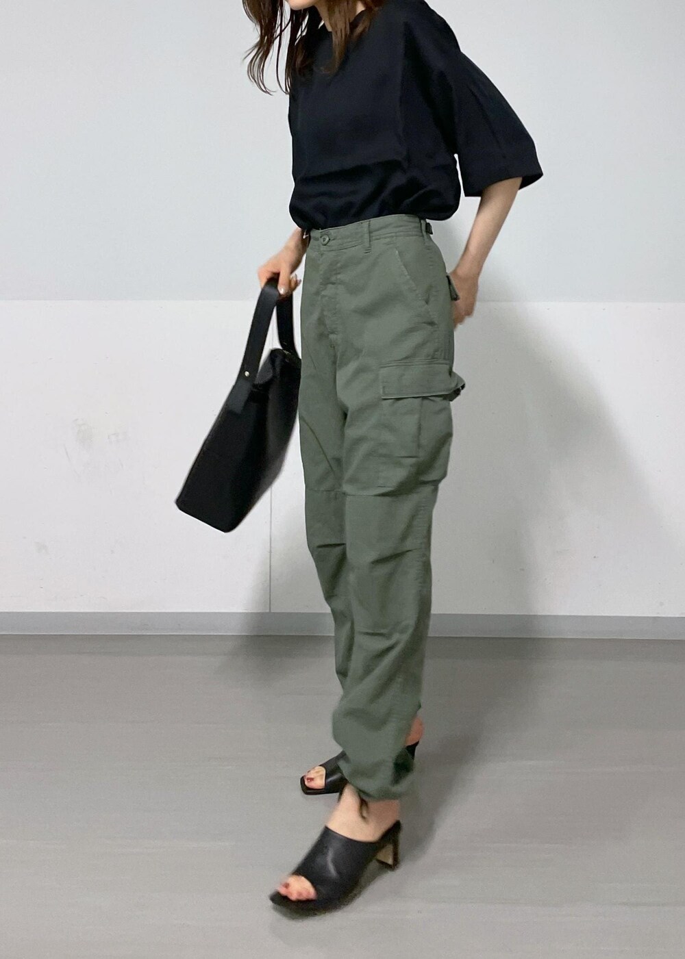 ホワイト系のトートバッグ、ブラック系のサンダル、グリーン系のカーゴパンツを着用したレディースの夏コーディネートの3枚目の写真