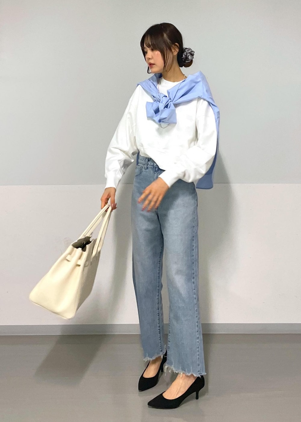 ブルー系のシャツ/ブラウス、ホワイト系のスウェット、ブルー系のデニムパンツを着用したレディースの冬コーディネートの3枚目の写真