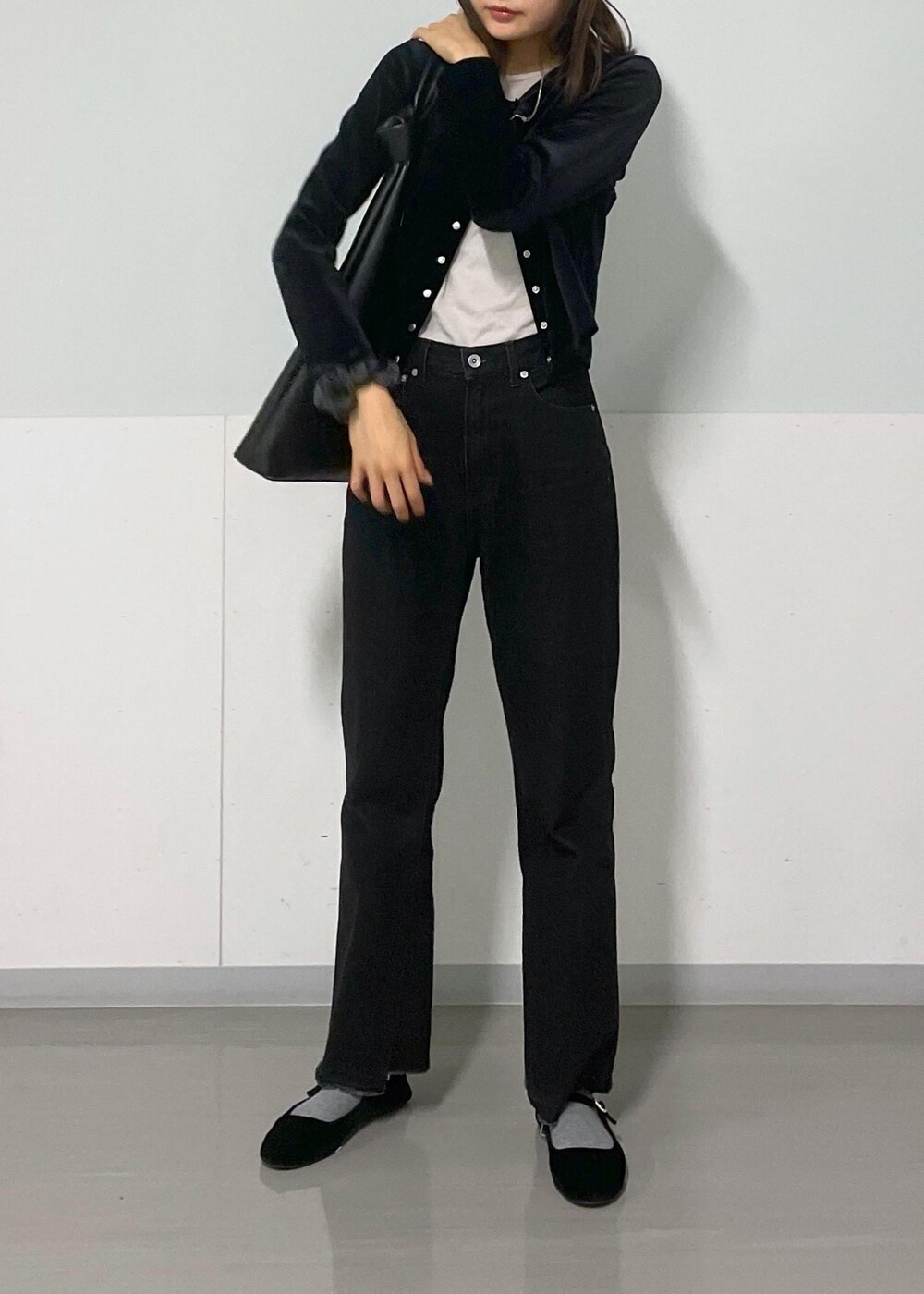 グレー系のTシャツ/カットソー、ブラック系のトートバッグ、グレー系のデニムパンツを着用したレディースの冬コーディネートの6枚目の写真