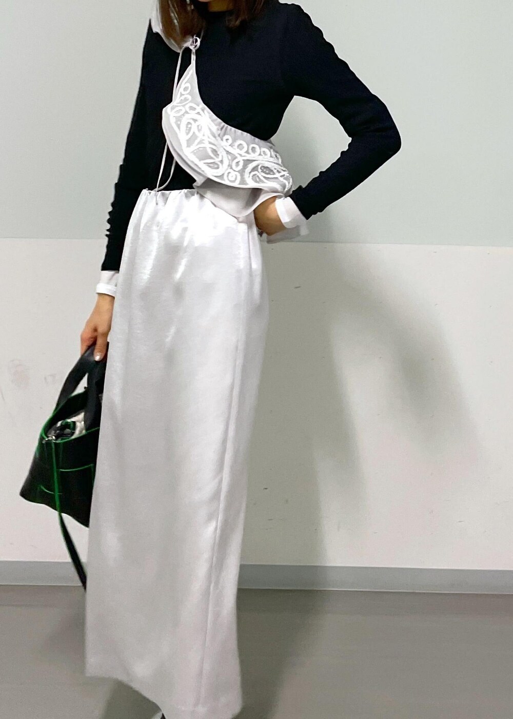 ブラック系のトートバッグ、ホワイト系のその他シューズ、ブラック系のTシャツ/カットソーを着用したレディースの冬コーディネートの6枚目の写真
