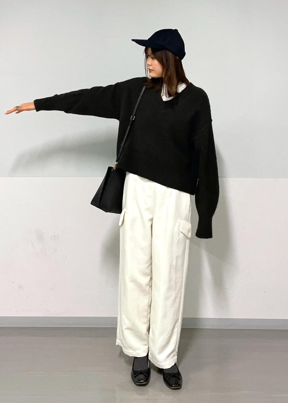 ブラウン系のニット/セーター、ホワイト系のカーゴパンツ、ホワイト系のTシャツ/カットソーを着用したレディースの冬コーディネートの8枚目の写真