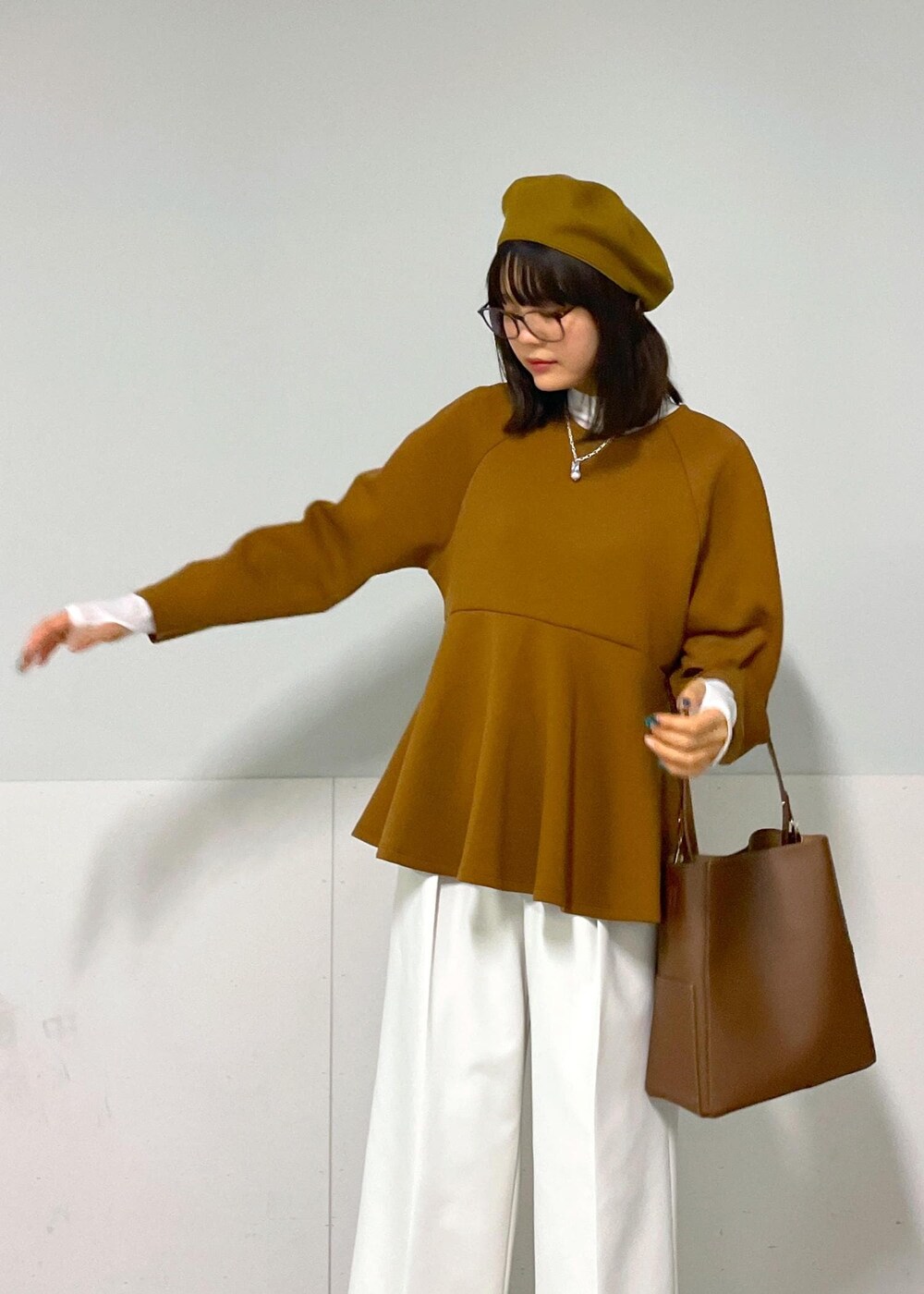 ブルー系のピーコート、ブラウン系のTシャツ/カットソー、ホワイト系のその他パンツを着用したレディースの秋コーディネートの4枚目の写真