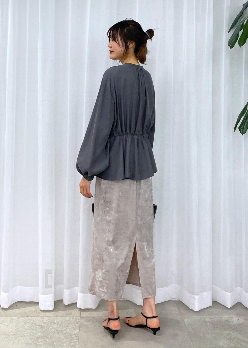 ブラック系のトートバッグ、ベージュ系のスカート、グレー系のシャツ/ブラウスを着用したレディースの冬コーディネートの4枚目の写真