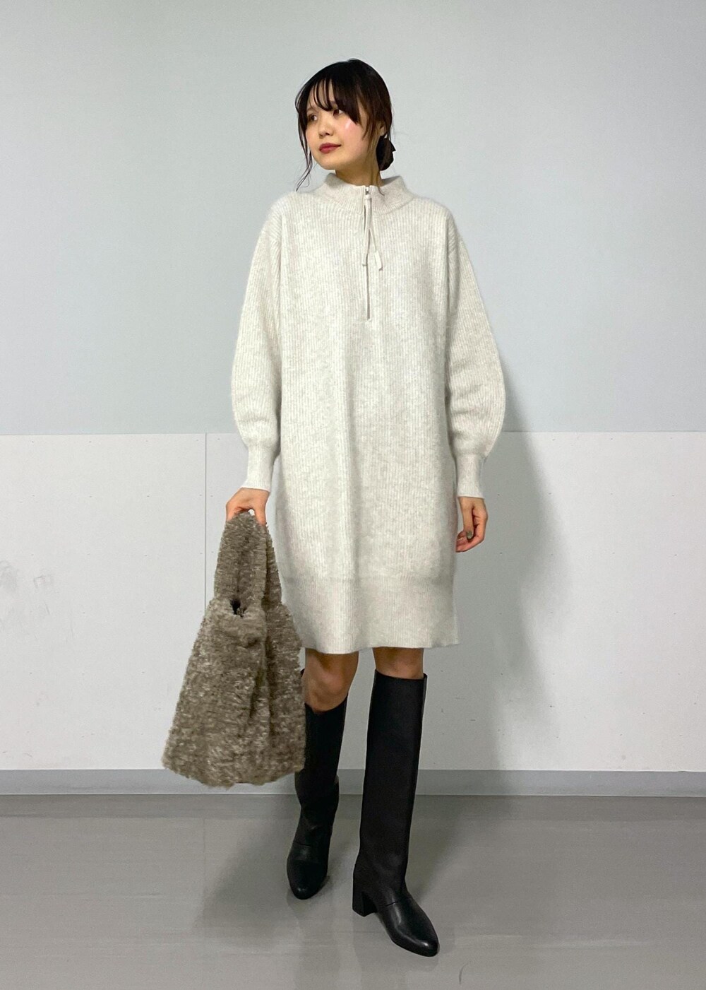 ホワイト系のワンピース、ブラック系のブーツ、ブラック系のTシャツ/カットソーを着用したレディースの秋コーディネートの2枚目の写真