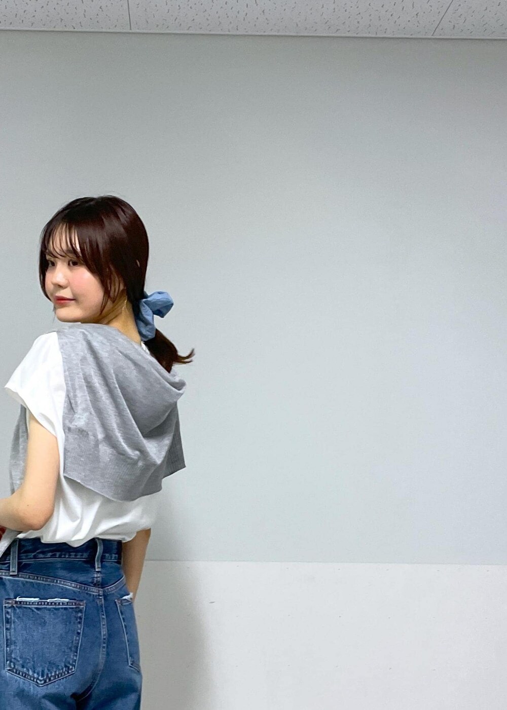 ホワイト系のかごバッグ、グレー系のカーディガン/ボレロ、ホワイト系のTシャツ/カットソーを着用したレディースの春コーディネートの9枚目の写真
