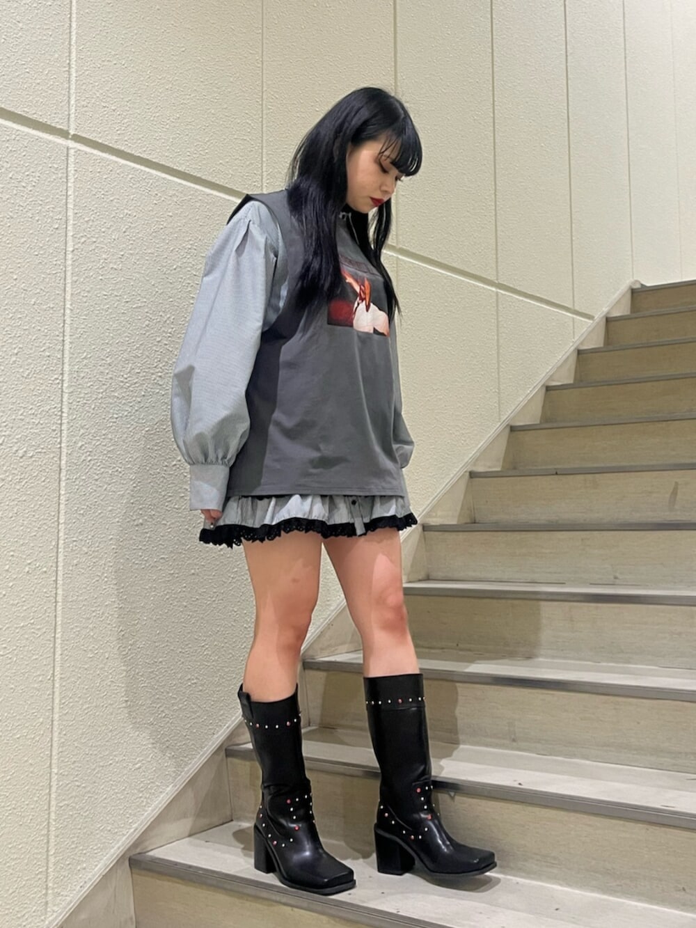 ブラック系のシャツ/ブラウス、ブラック系のTシャツ/カットソー、ブラック系のブーツを着用したレディースの春コーディネートの3枚目の写真