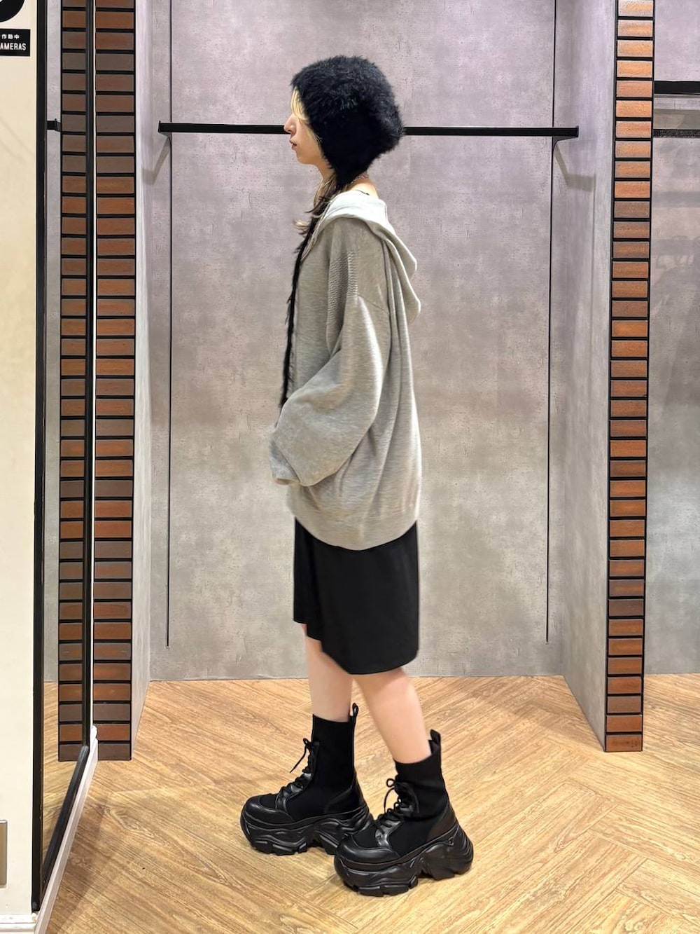グレー系のパーカー、ブラック系のその他パンツ、ブラック系のブーツを着用したレディースの秋コーディネートの3枚目の写真