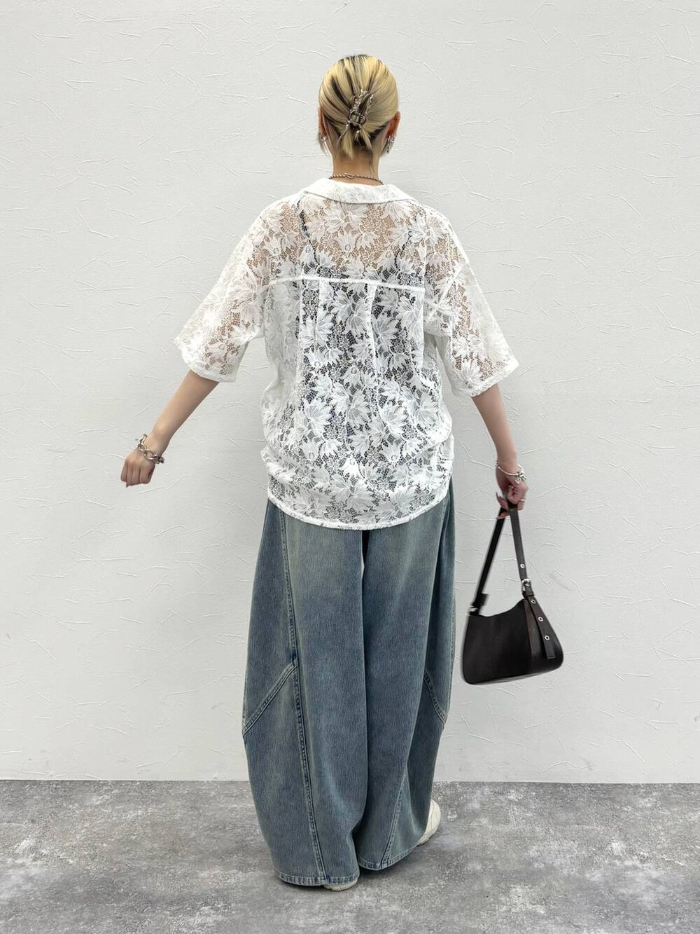 ホワイト系のシャツ/ブラウス、ホワイト系のスニーカー、ブラウン系のハンドバッグを着用したレディースの春コーディネートの4枚目の写真