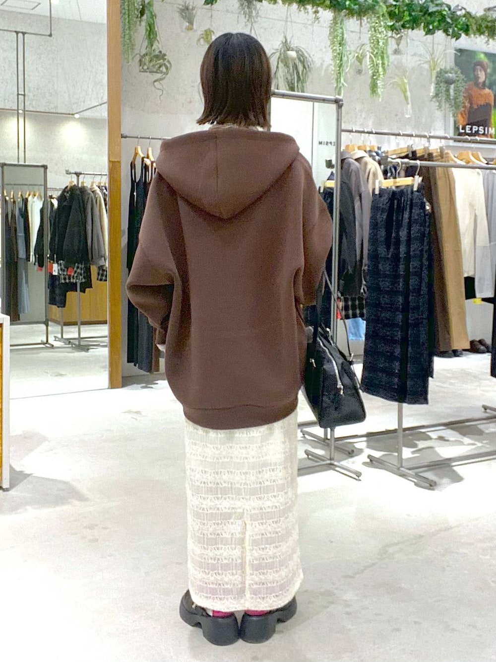 ブラック系のTシャツ/カットソー、ブラック系のサンダル、ブラウン系のパーカーを着用したレディースの冬コーディネートの3枚目の写真