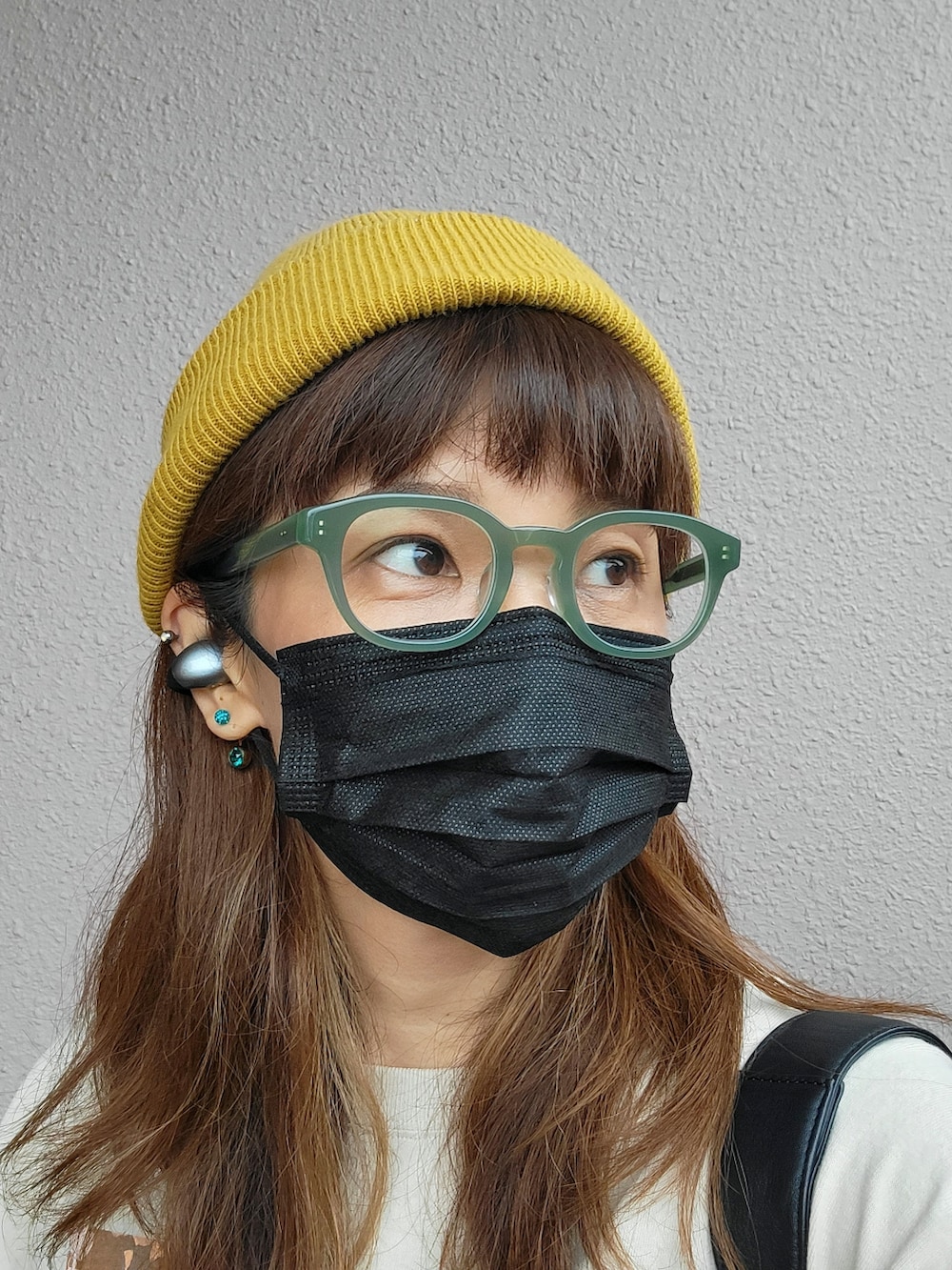 グリーン系のカーゴパンツ、ブラック系のバックパック/リュック、ベージュ系のTシャツ/カットソーを着用したレディースの秋コーディネートの3枚目の写真