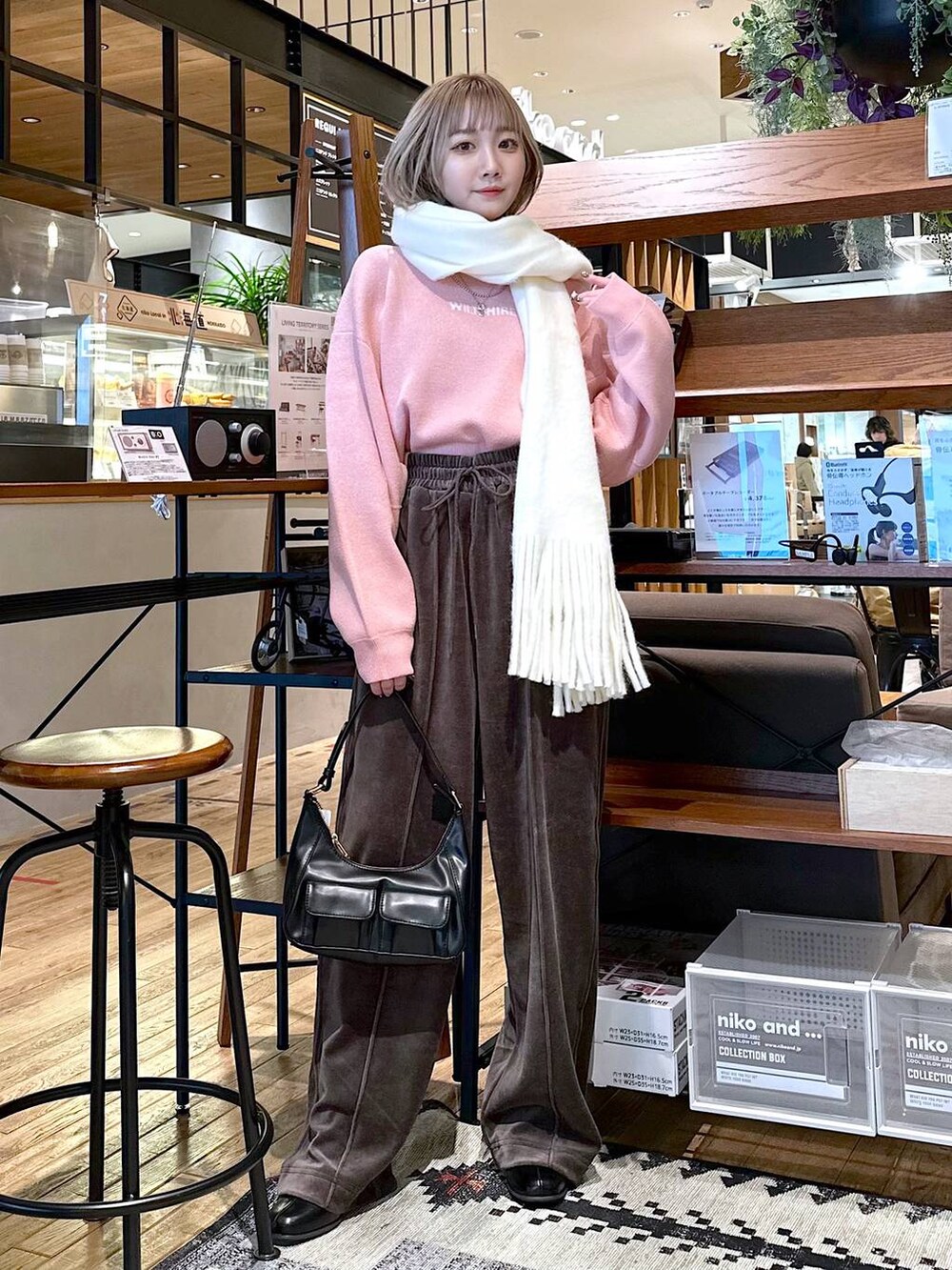 ブラウン系のその他パンツ、ブラック系のブーツ、ピンク系のニット/セーターを着用したレディースの冬コーディネートの4枚目の写真