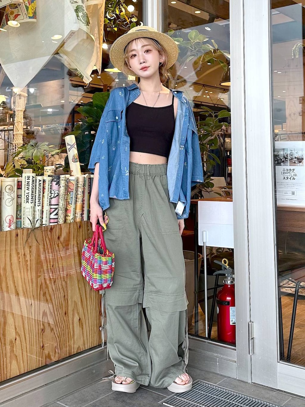 グリーン系のその他パンツ、レッド系のハンドバッグ、ベージュ系のサンダルを着用したレディースの春コーディネートの3枚目の写真