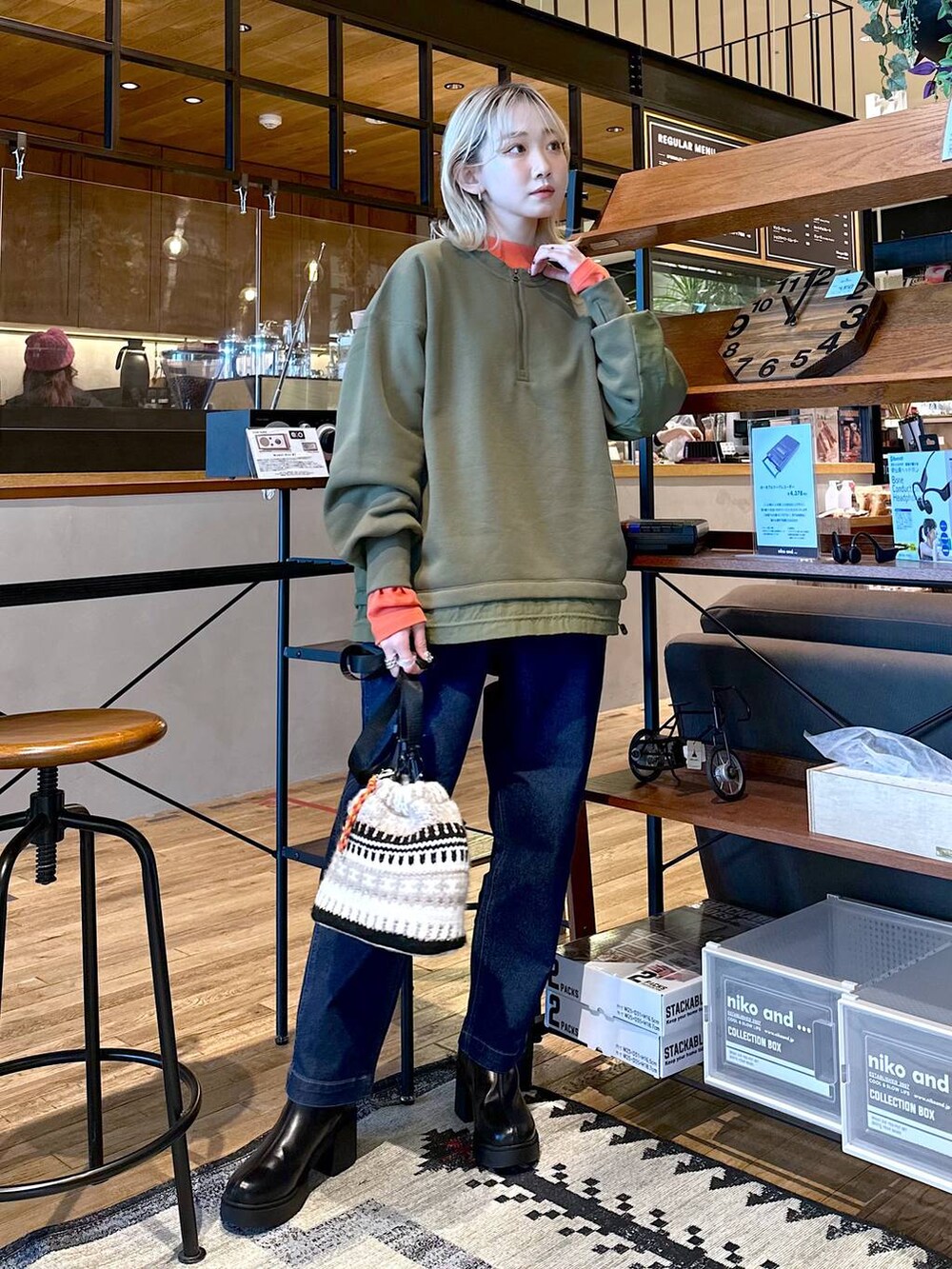 ブルー系のその他パンツ、ブラック系のブーツ、オレンジ系のTシャツ/カットソーを着用したレディースの冬コーディネートの3枚目の写真