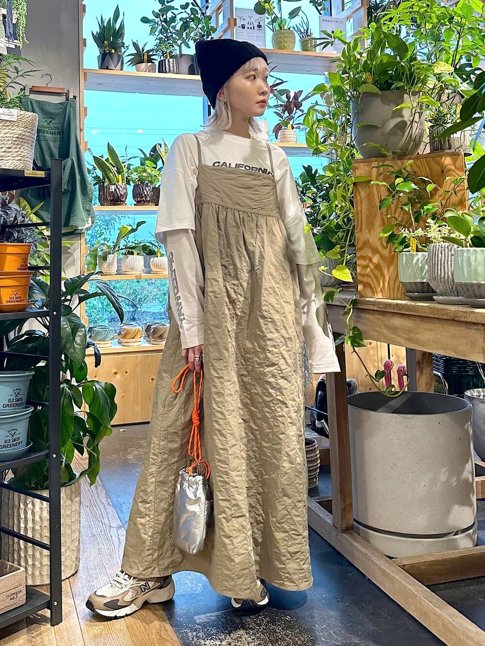 ブラウン系のスニーカー、グレー系のショルダーバッグ、ホワイト系のTシャツ/カットソーを着用したレディースの秋コーディネートの4枚目の写真