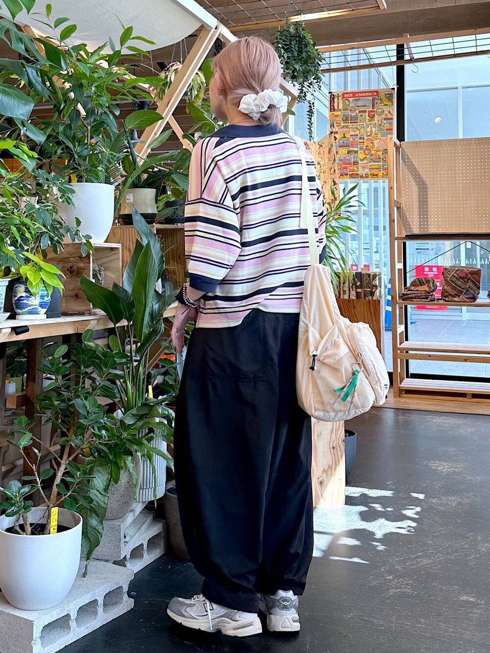 ブラック系のその他パンツ、ベージュ系のポロシャツ、ベージュ系のショルダーバッグを着用したレディースの夏コーディネートの4枚目の写真