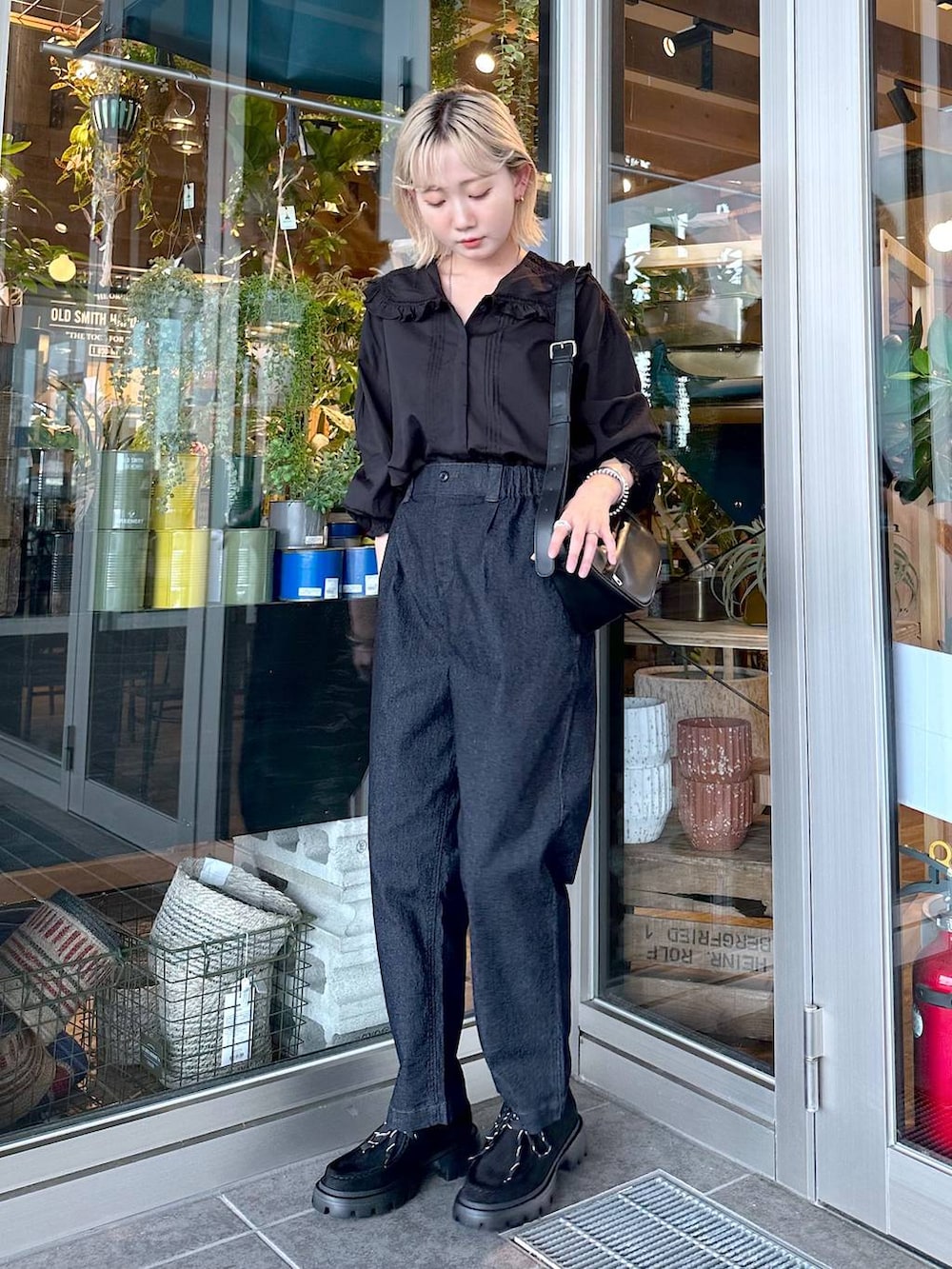 ブラック系のその他パンツ、ブラック系のショルダーバッグ、ブラック系のモカシン/デッキシューズを着用したレディースの夏コーディネートの2枚目の写真