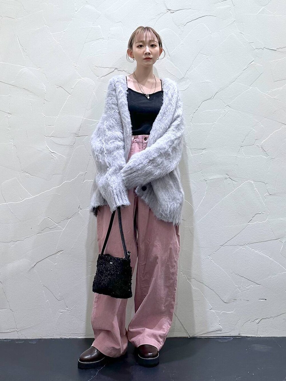 ピンク系のその他パンツ、ブラウン系のその他シューズ、ブラック系のショルダーバッグを着用したレディースの冬コーディネートの3枚目の写真