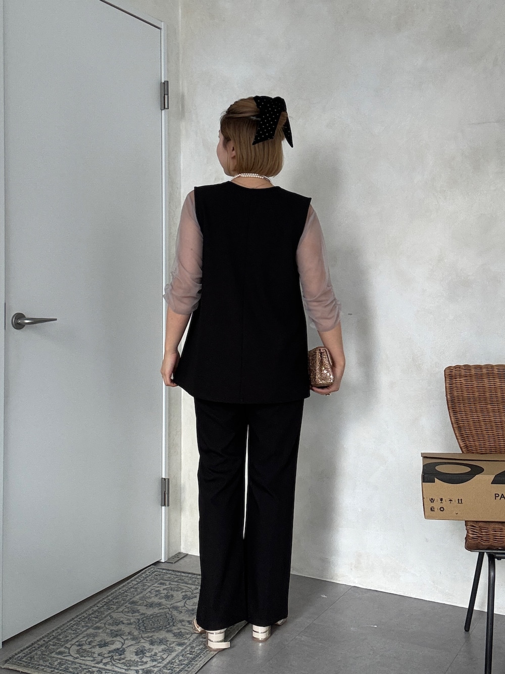 ブラック系のドレス、ホワイト系のパンツドレス、ホワイト系のネックレスを着用したレディースの冬コーディネートの3枚目の写真