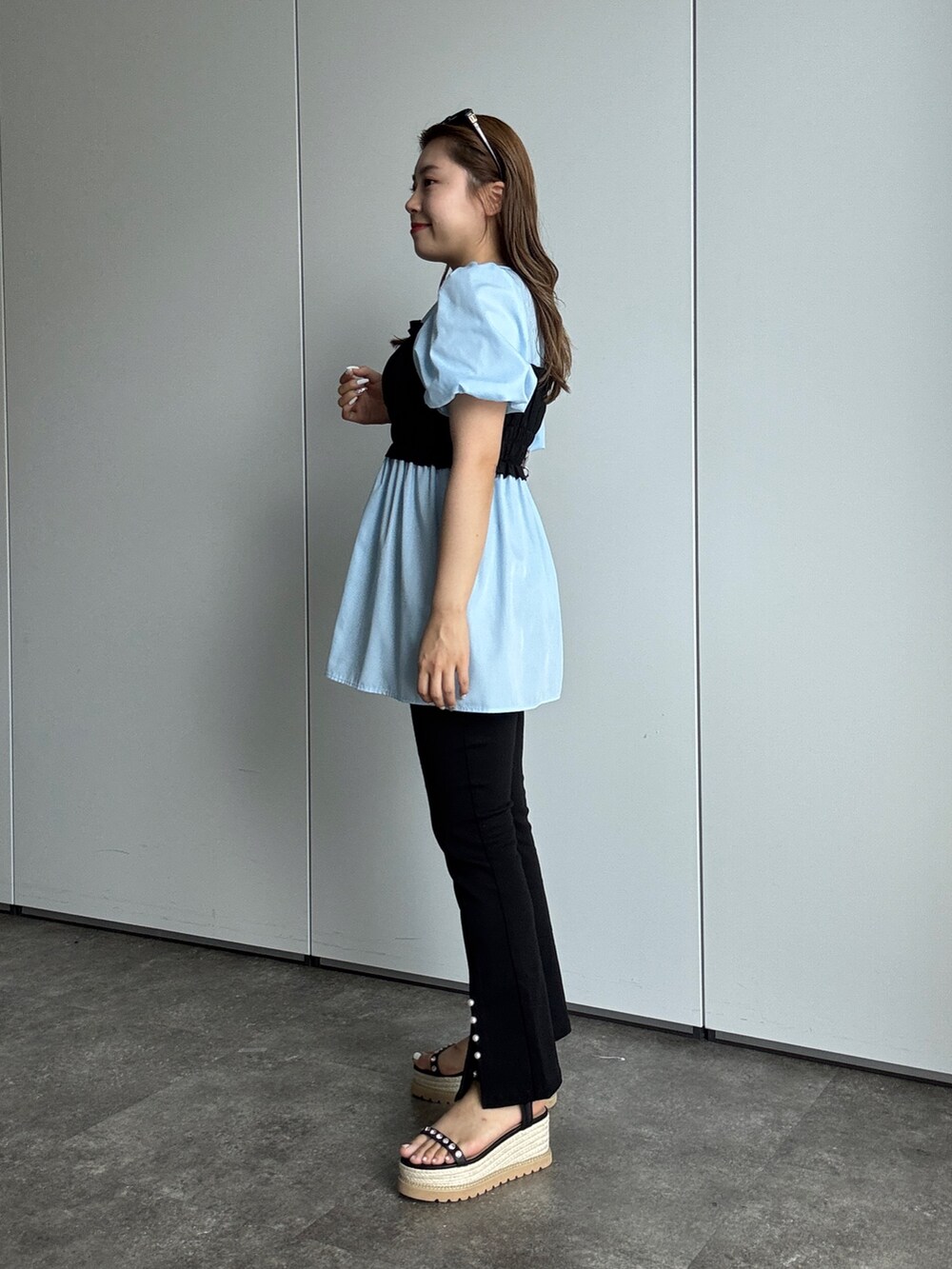 ブルー系のシャツ/ブラウス、シルバー系のショルダーバッグ、ブラック系のその他パンツを着用したレディースの夏コーディネートの2枚目の写真