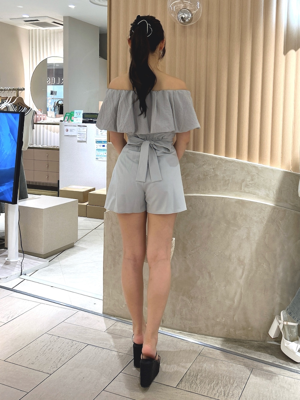 ブルー系のつなぎ/オールインワン、ベージュ系のハンドバッグ、ブラック系のサンダルを着用したレディースの夏コーディネートの5枚目の写真