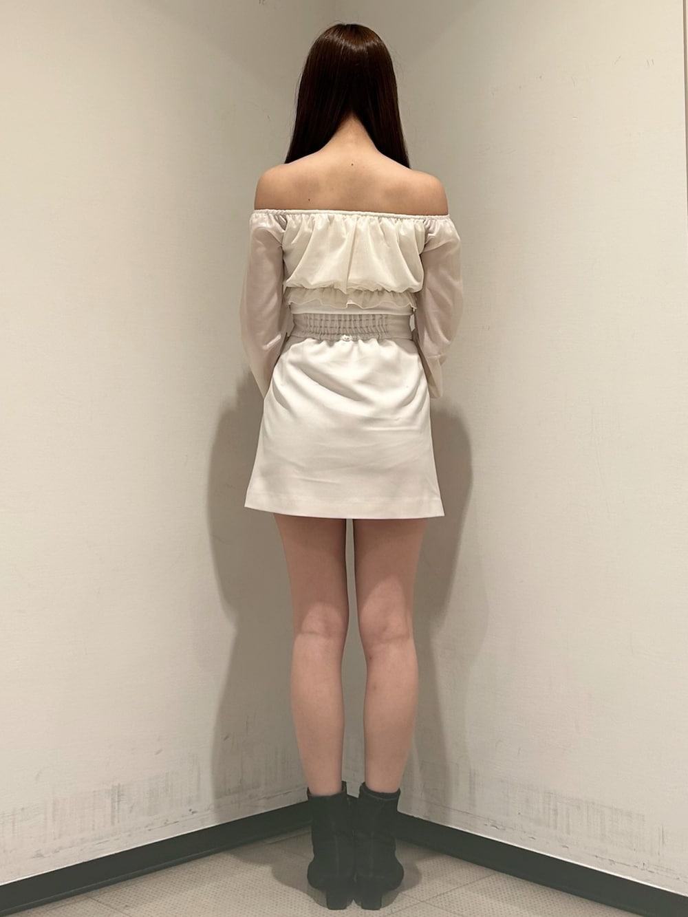 ホワイト系のスカート、ホワイト系のTシャツ/カットソー、ベージュ系のトレンチコートを着用したレディースの春コーディネートの5枚目の写真