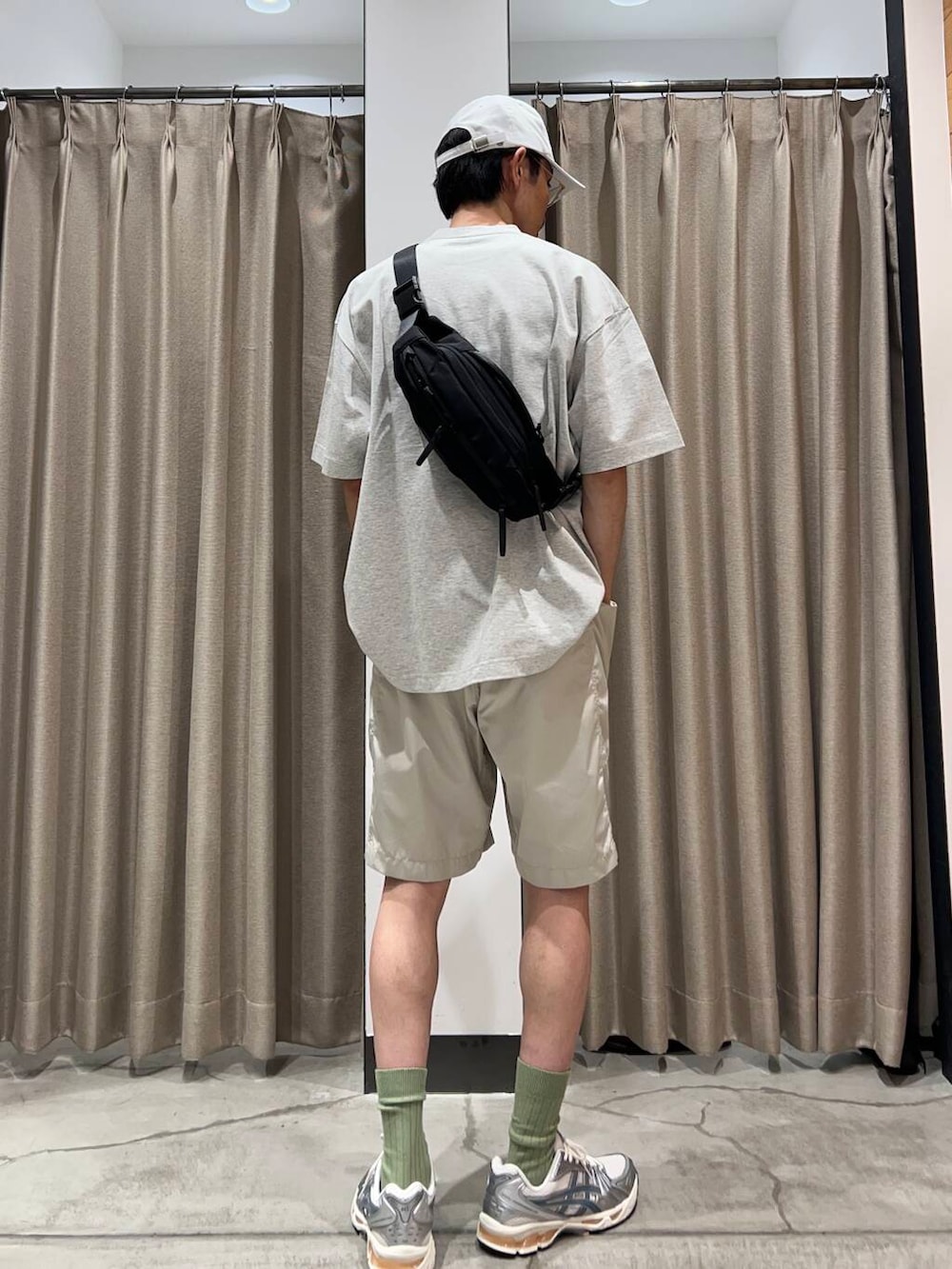 ブラック系のショルダーバッグ、グレー系のTシャツ/カットソー、ホワイト系のスニーカーを着用したメンズの夏コーディネートの3枚目の写真