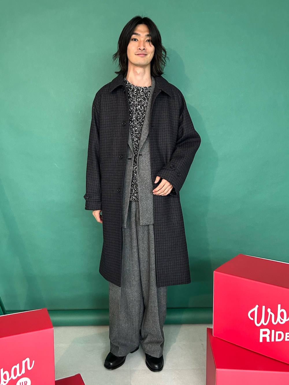 ブラック系のニット/セーター、グレー系のスラックス、その他のステンカラーコートを着用したメンズの冬コーディネートの2枚目の写真