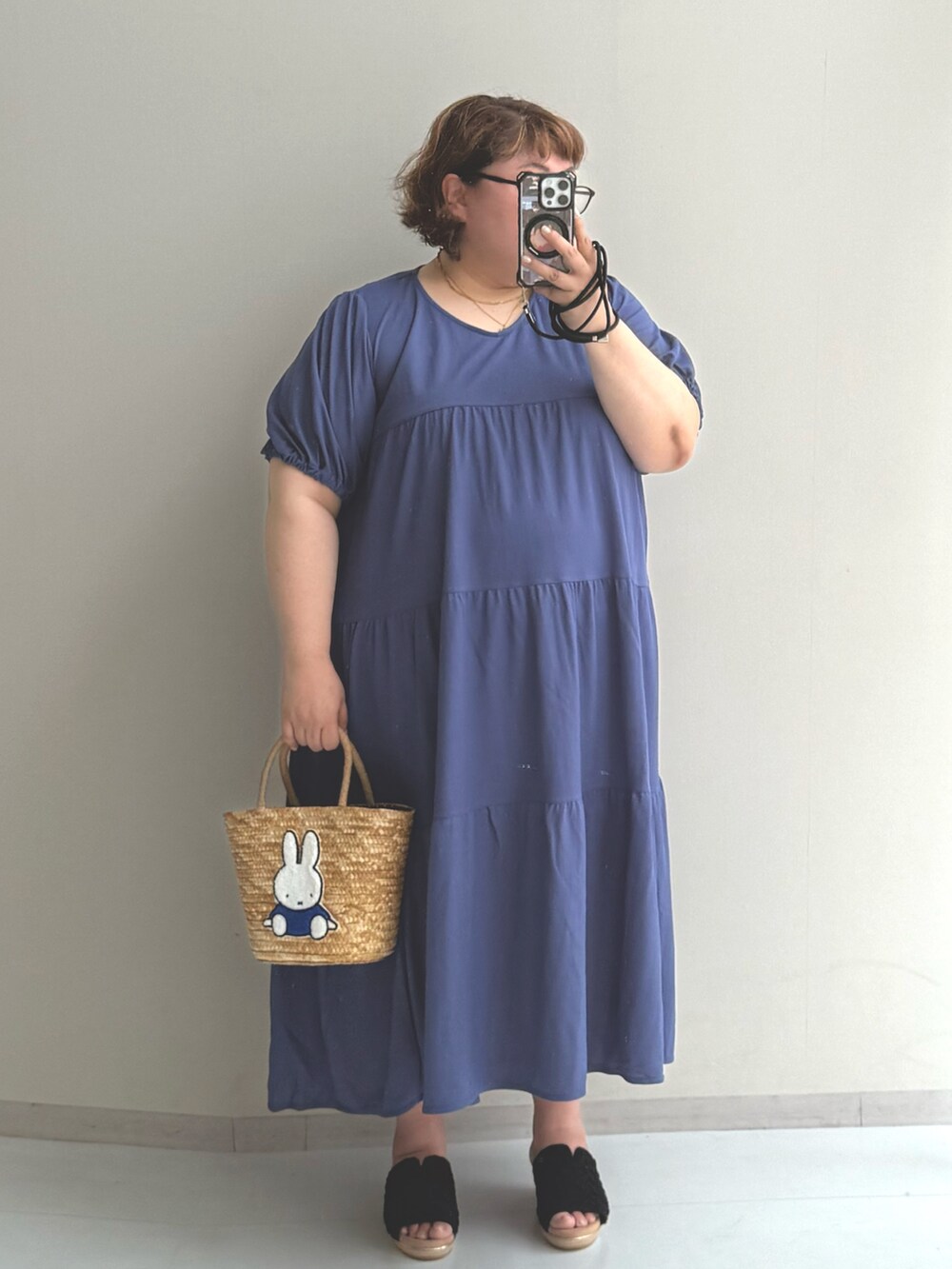 ブルー系のトートバッグ、ブルー系のワンピース、ホワイト系のパンツを着用したレディースの夏コーディネートの2枚目の写真