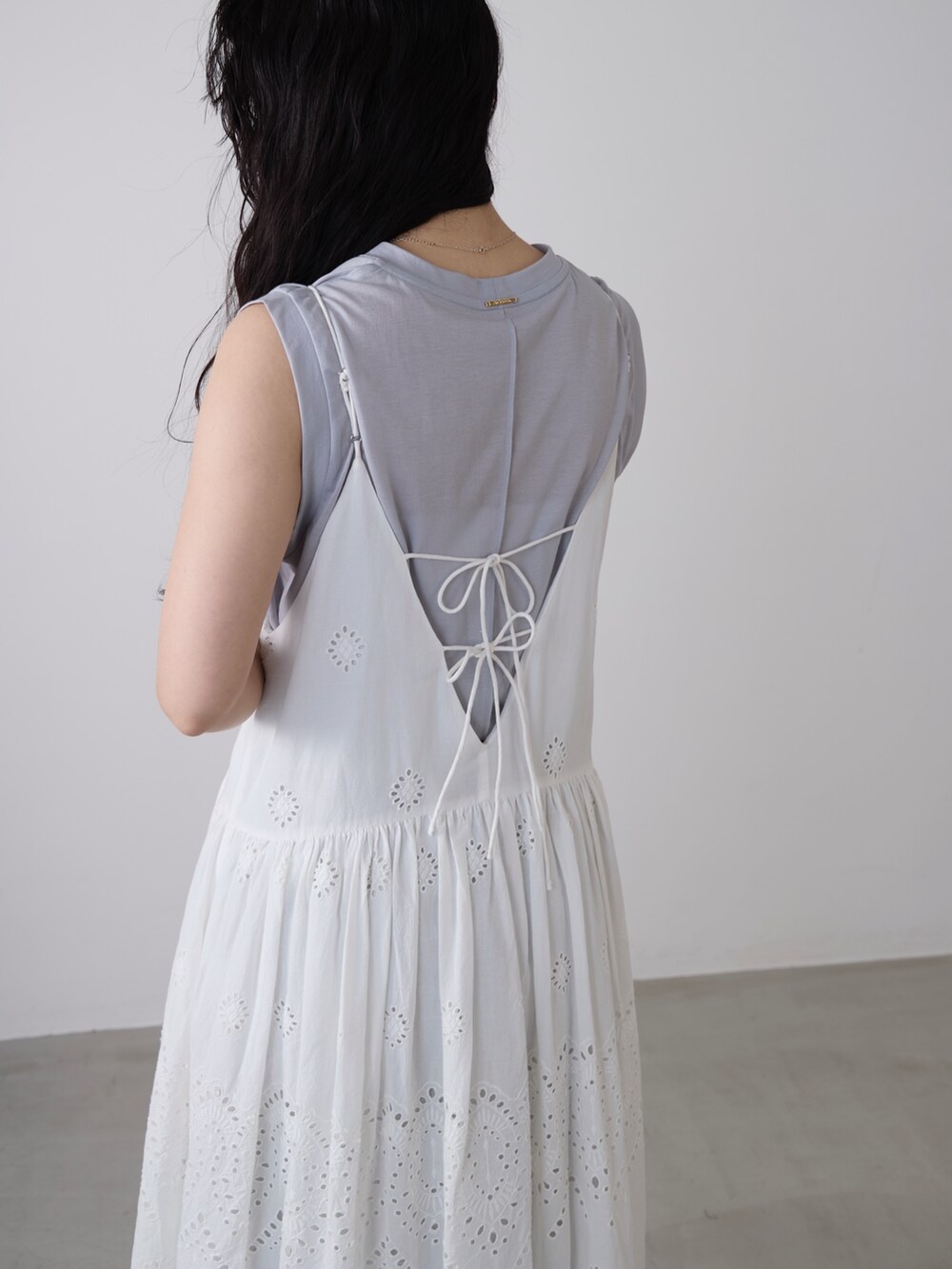 ホワイト系のワンピース、グレー系のタンクトップ、ブラウン系のその他パンツを着用したレディースの春コーディネートの4枚目の写真