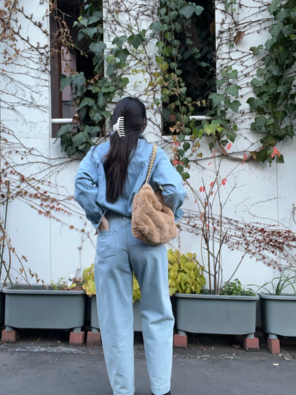 ベージュ系のショルダーバッグ、ブルー系のデニムパンツ、ブルー系のシャツ/ブラウスを着用したレディースの冬コーディネートの3枚目の写真