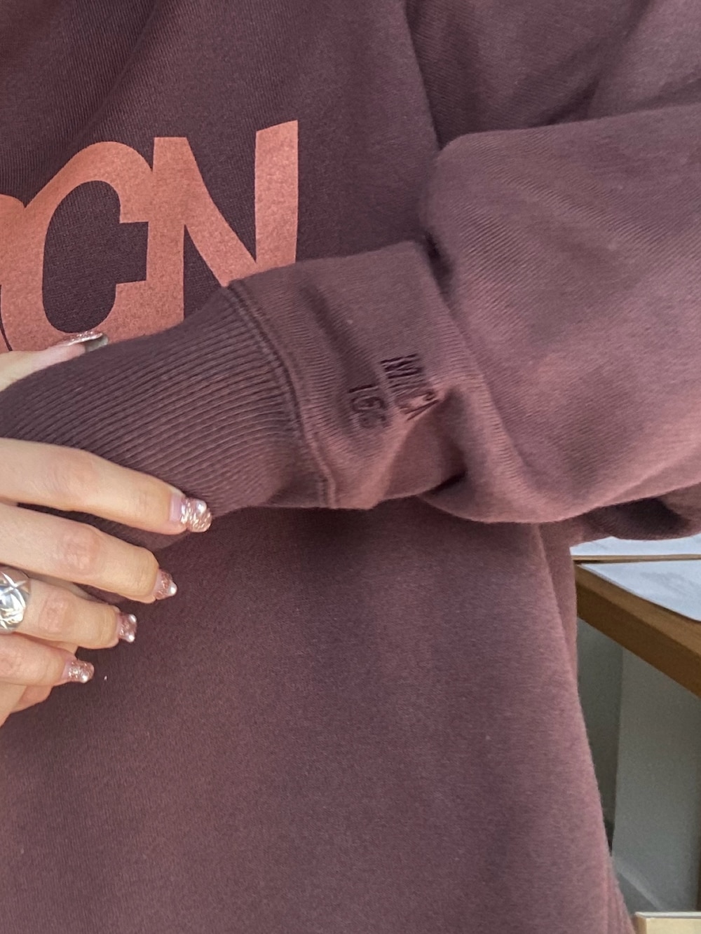 ブラウン系のパーカー、グレー系のスカートを着用したレディースの秋コーディネートの2枚目の写真