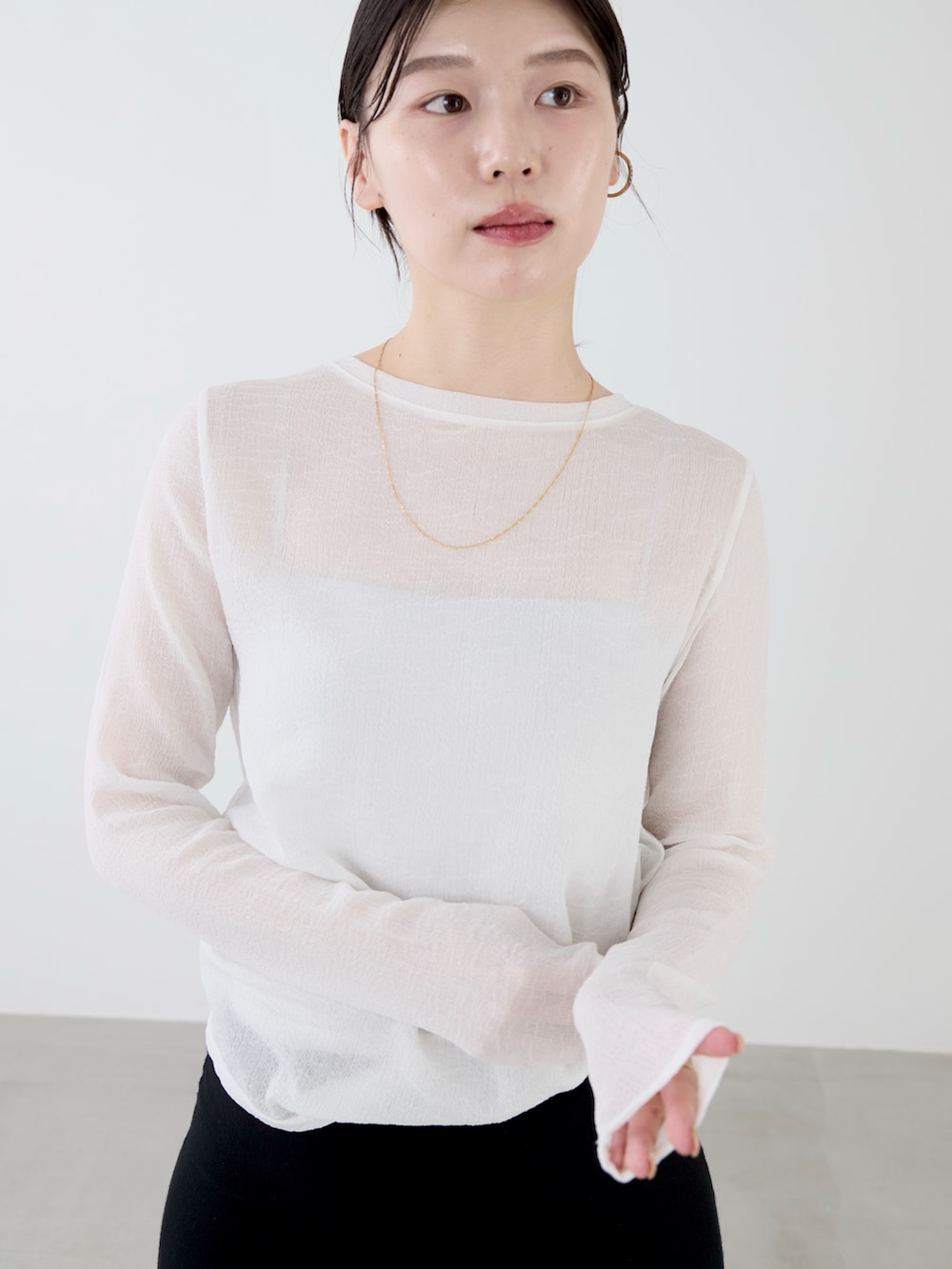 ホワイト系のTシャツ/カットソー、グリーン系のミリタリージャケット、ブラック系のスカートを着用したレディースの秋コーディネートの4枚目の写真