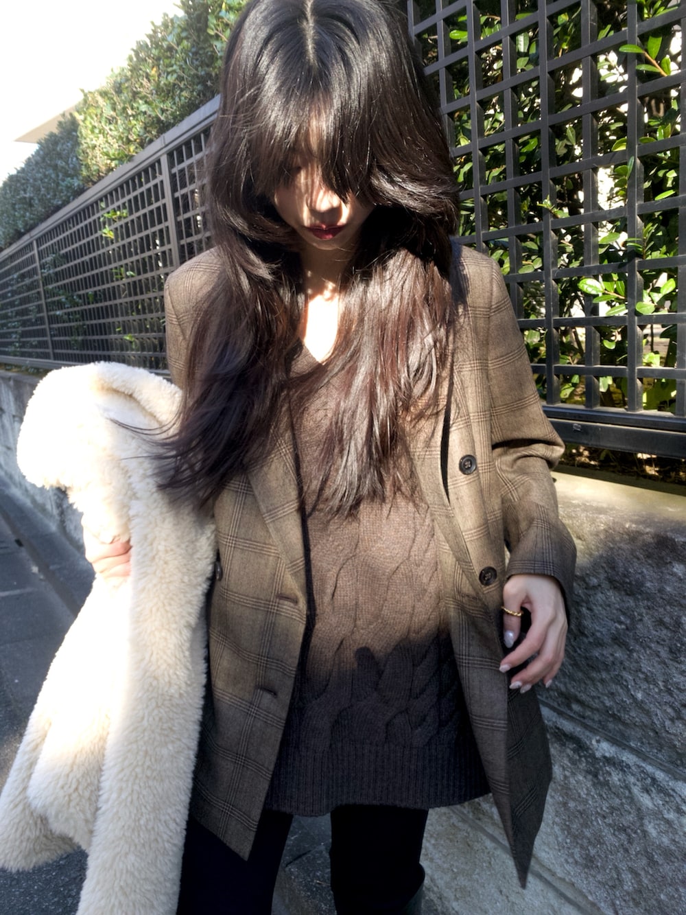 ベージュ系のブルゾン、ブラウン系のテーラードジャケット、ブラウン系のニット/セーターを着用したレディースの冬コーディネートの9枚目の写真