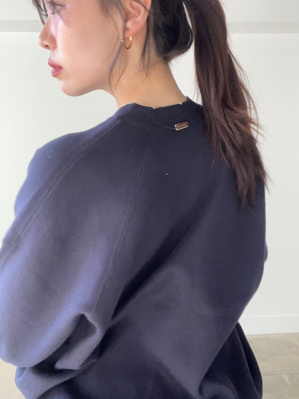 ブルー系のニット/セーター、グリーン系のスカートを着用したレディースの春コーディネートの4枚目の写真