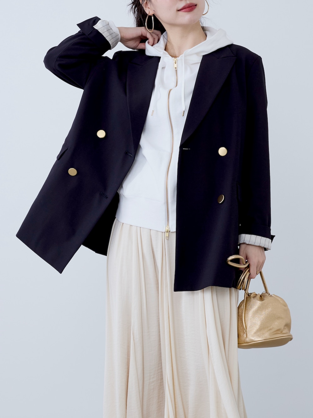 ブルー系のテーラードジャケット、ベージュ系のスカートを着用したレディースの冬コーディネートの6枚目の写真