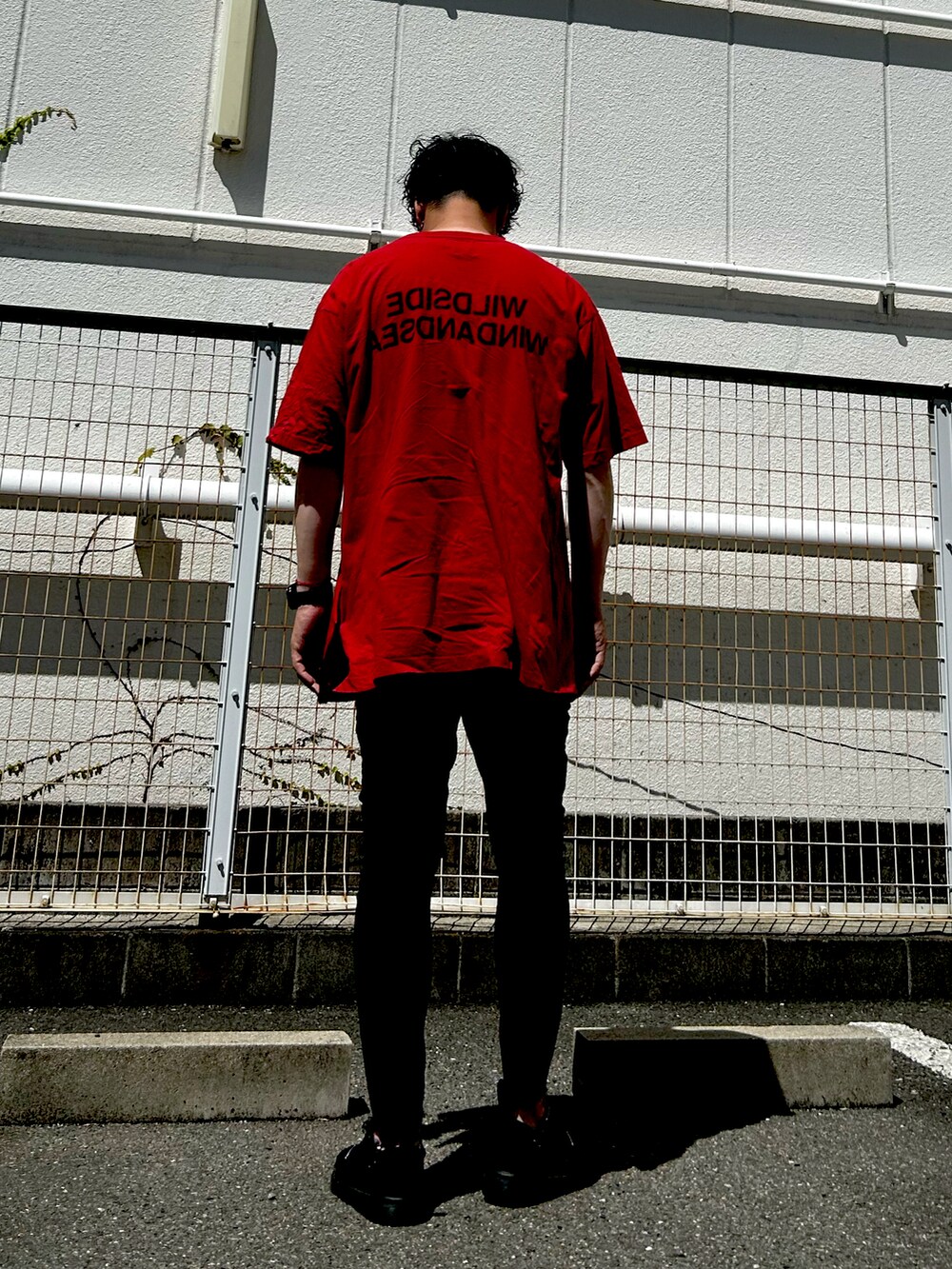 レッド系のTシャツ/カットソー、レッド系のTシャツ/カットソー、ブラック系のデニムパンツを着用したメンズの夏コーディネートの3枚目の写真