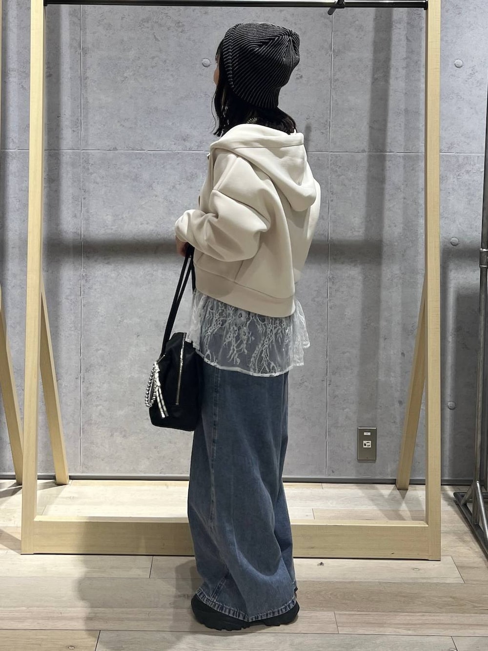 ホワイト系のTシャツ/カットソー、ブルー系のデニムパンツ、ブラック系のボストンバッグを着用したレディースの冬コーディネートの2枚目の写真