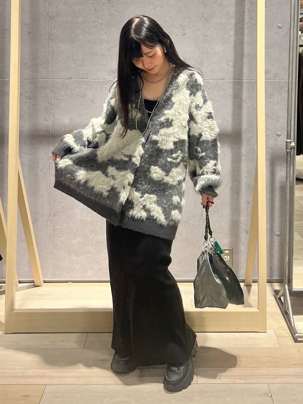 その他のショルダーバッグ、ブラック系のスカート、グレー系のカーディガン/ボレロを着用したレディースの秋コーディネートの2枚目の写真