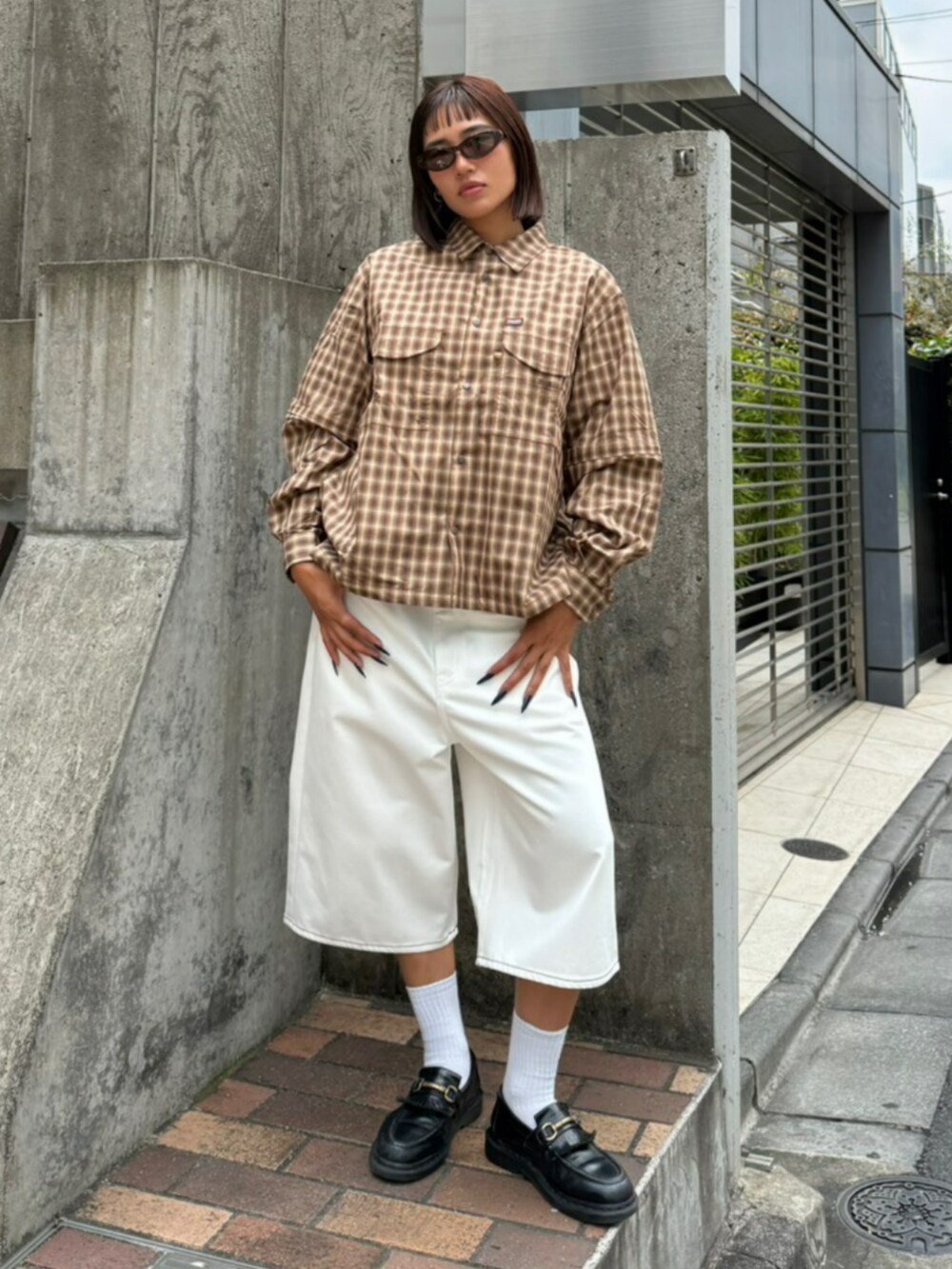 ホワイト系のデニムパンツ、ブラウン系のシャツ/ブラウス、ブラウン系のサングラスを着用したレディースの夏コーディネートの2枚目の写真