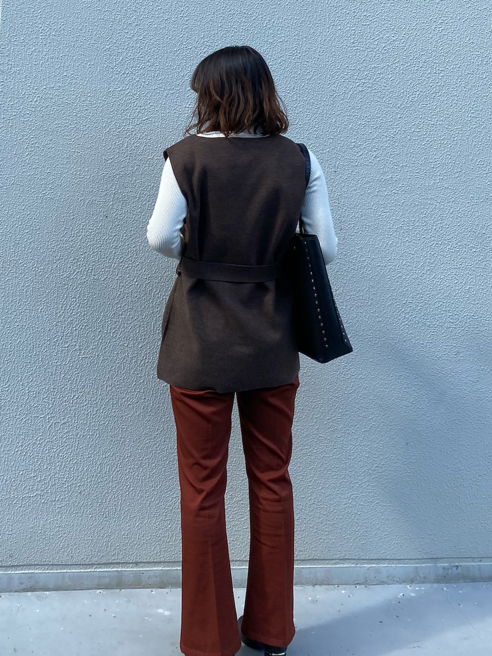 ブラック系のトートバッグ、ブラウン系のニット/セーターを着用したレディースの秋コーディネートの2枚目の写真