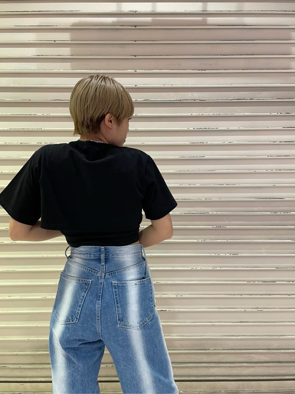 ブルー系のデニムパンツ、ブラック系のTシャツ/カットソー、シルバー系のネックレスを着用したレディースの春コーディネートの6枚目の写真