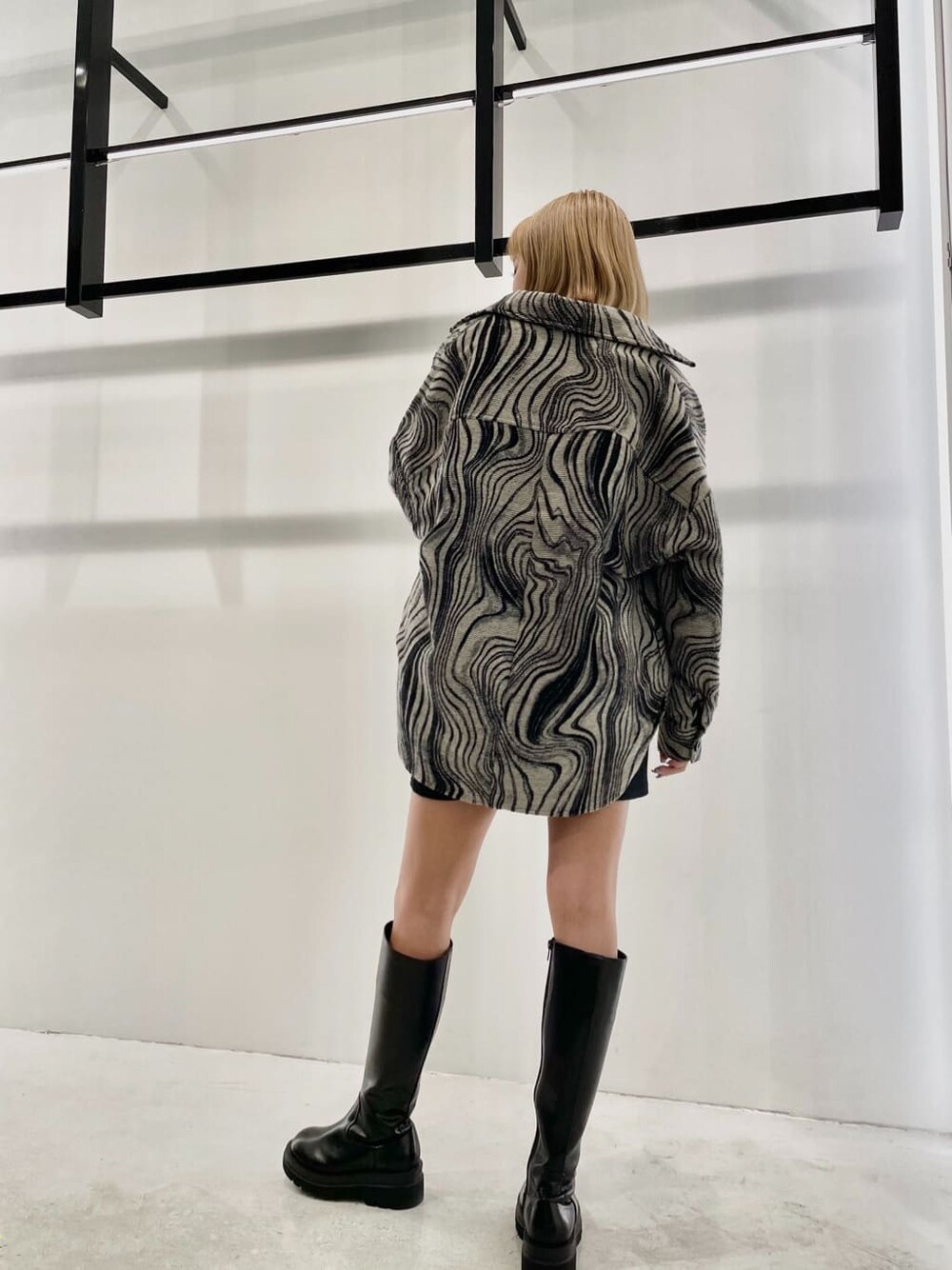 ブラック系のワンピース、その他のブルゾン、ブラック系のブーツを着用したレディースの秋コーディネートの3枚目の写真