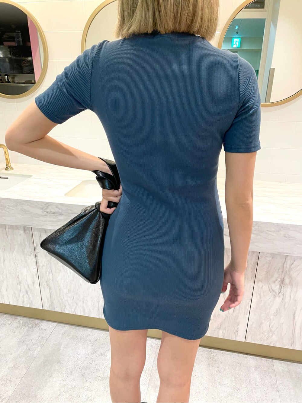 ブルー系のワンピース、ブラック系のサンダル、ブラック系のハンドバッグを着用したレディースの夏コーディネートの6枚目の写真