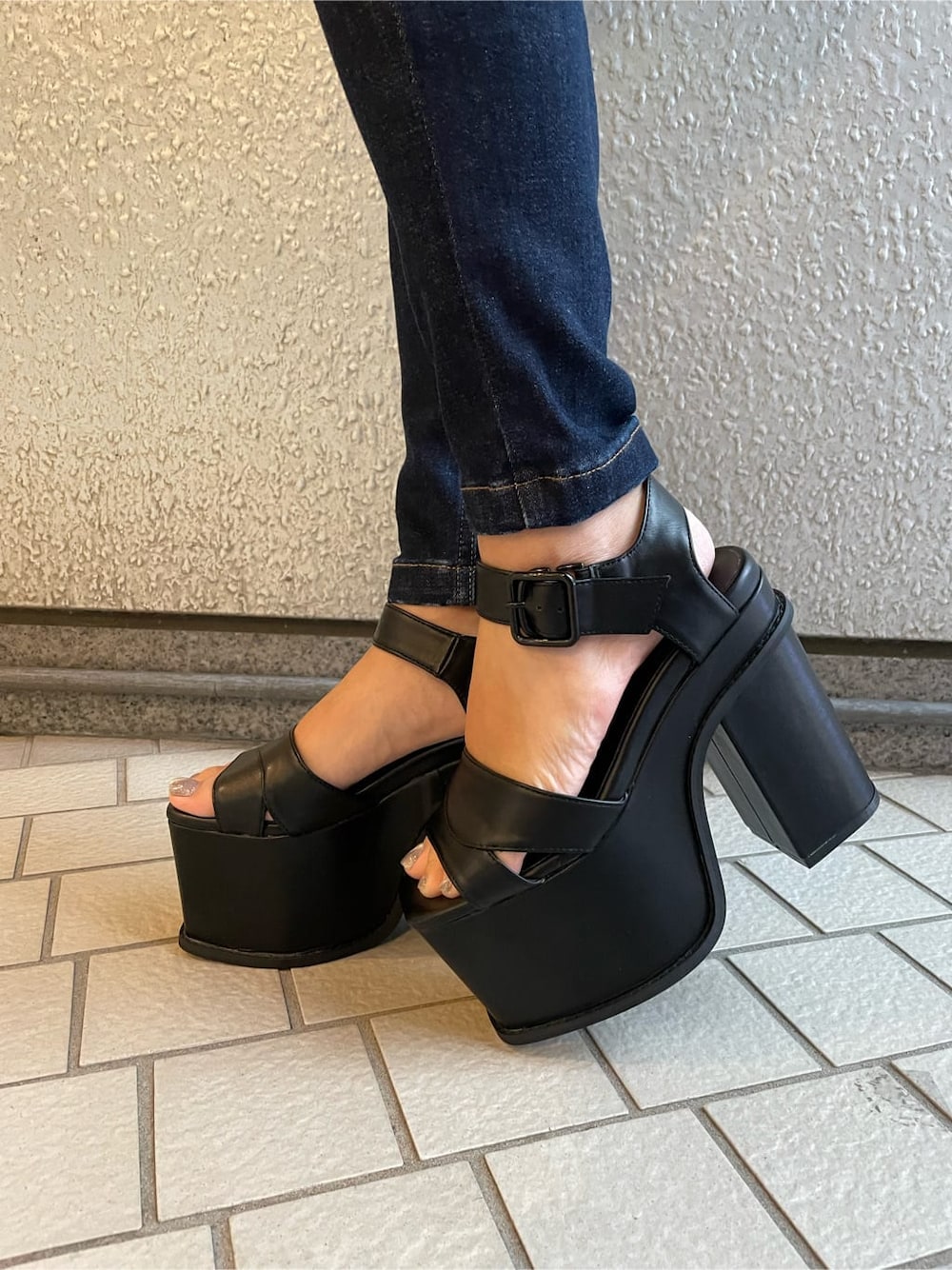 ブルー系のデニムパンツ、ブラック系のサンダル、ブラック系のTシャツ/カットソーを着用したレディースの夏コーディネートの7枚目の写真