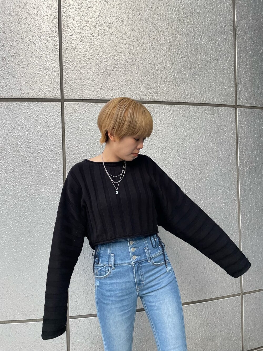 ブラック系のニット/セーター、ブラック系のローファー、ブルー系のデニムパンツを着用したレディースの冬コーディネートの4枚目の写真