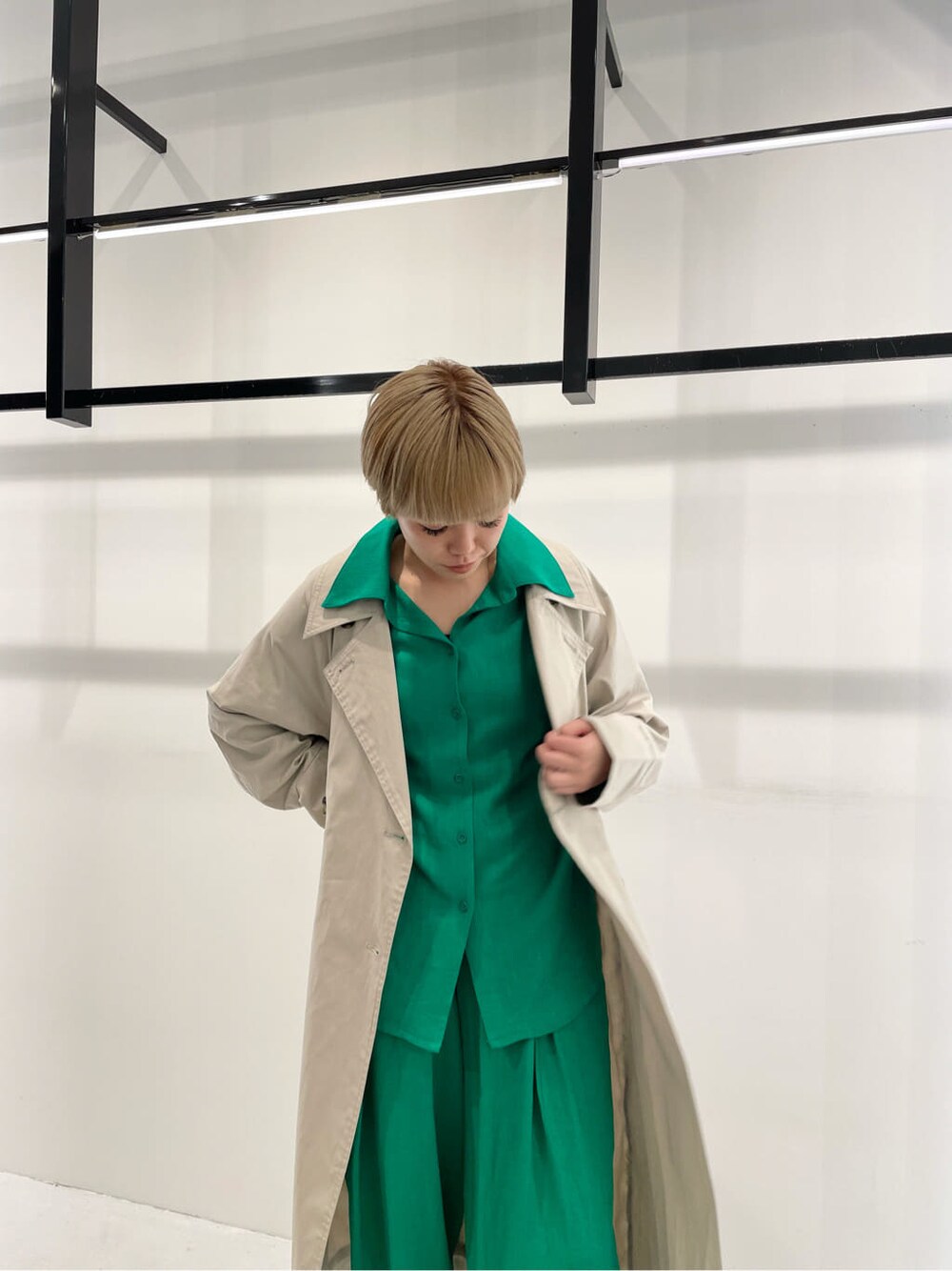 グリーン系のシャツ/ブラウス、グリーン系のその他パンツ、ベージュ系のトレンチコートを着用したレディースの冬コーディネートの5枚目の写真