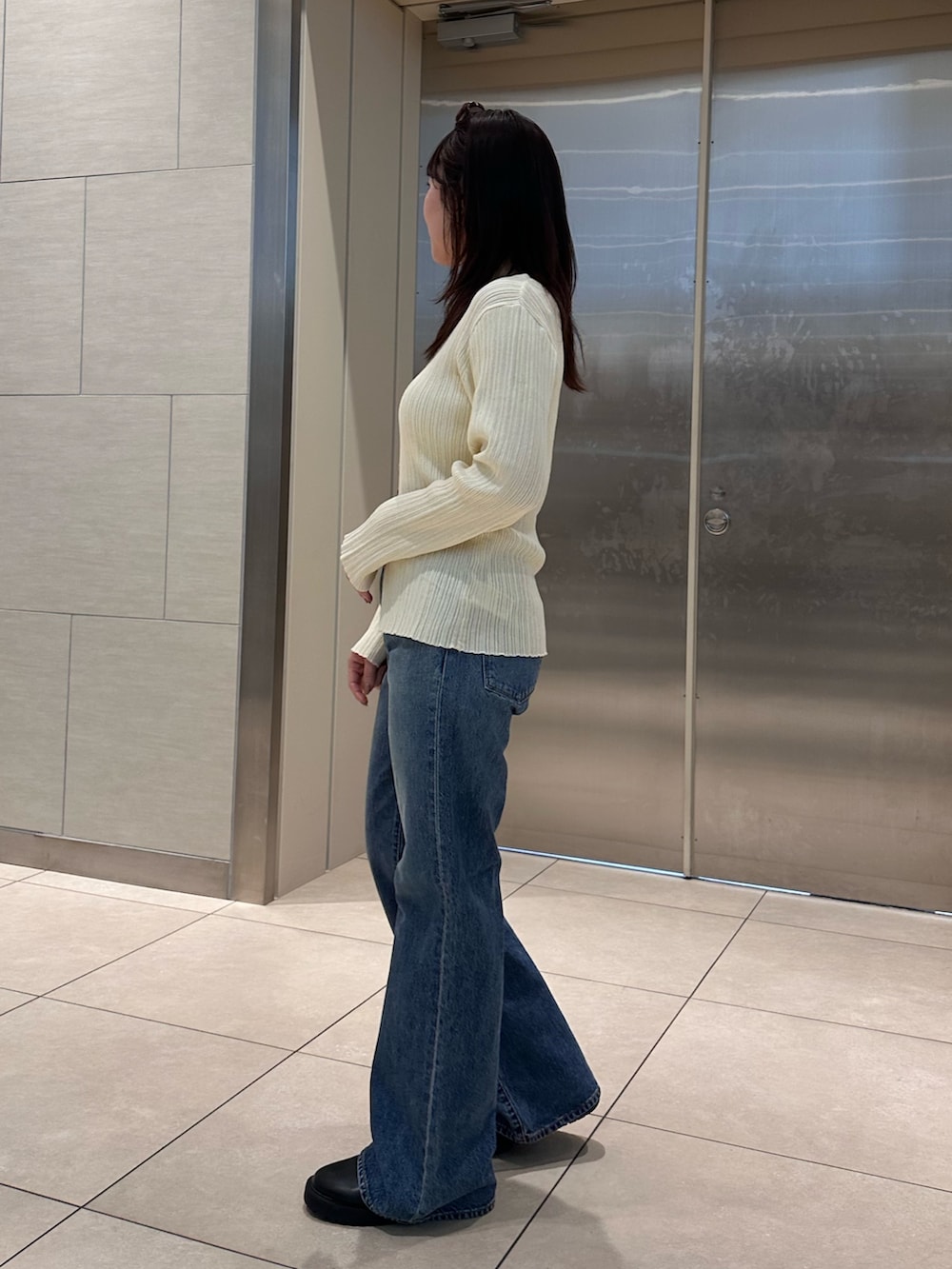 ホワイト系のカーディガン/ボレロ、ブルー系のデニムパンツを着用したレディースの冬コーディネートの4枚目の写真