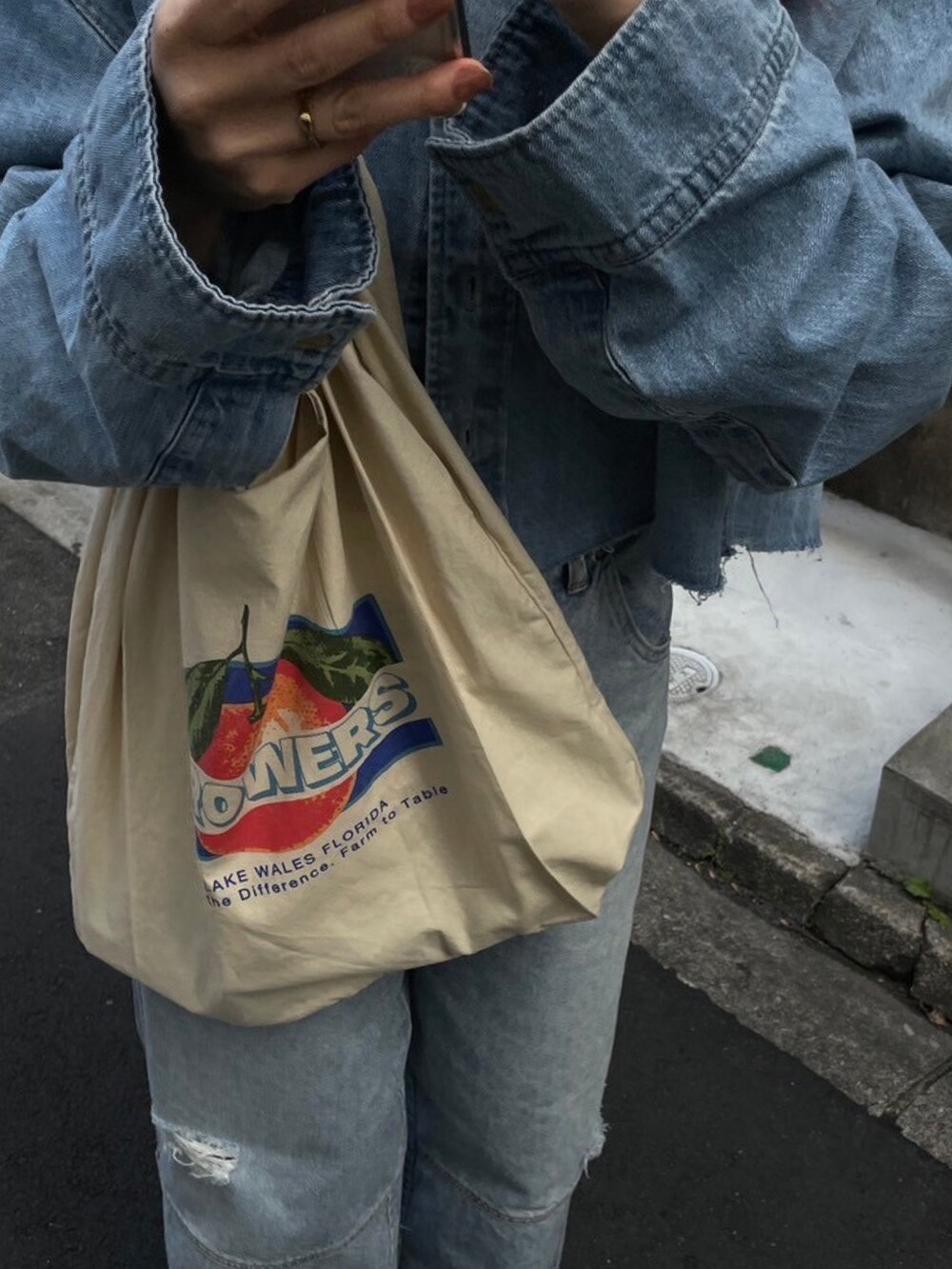 ブルー系のシャツ/ブラウス、ブルー系のデニムパンツ、ホワイト系のエコバッグ/サブバッグを着用したレディースの冬コーディネートの8枚目の写真