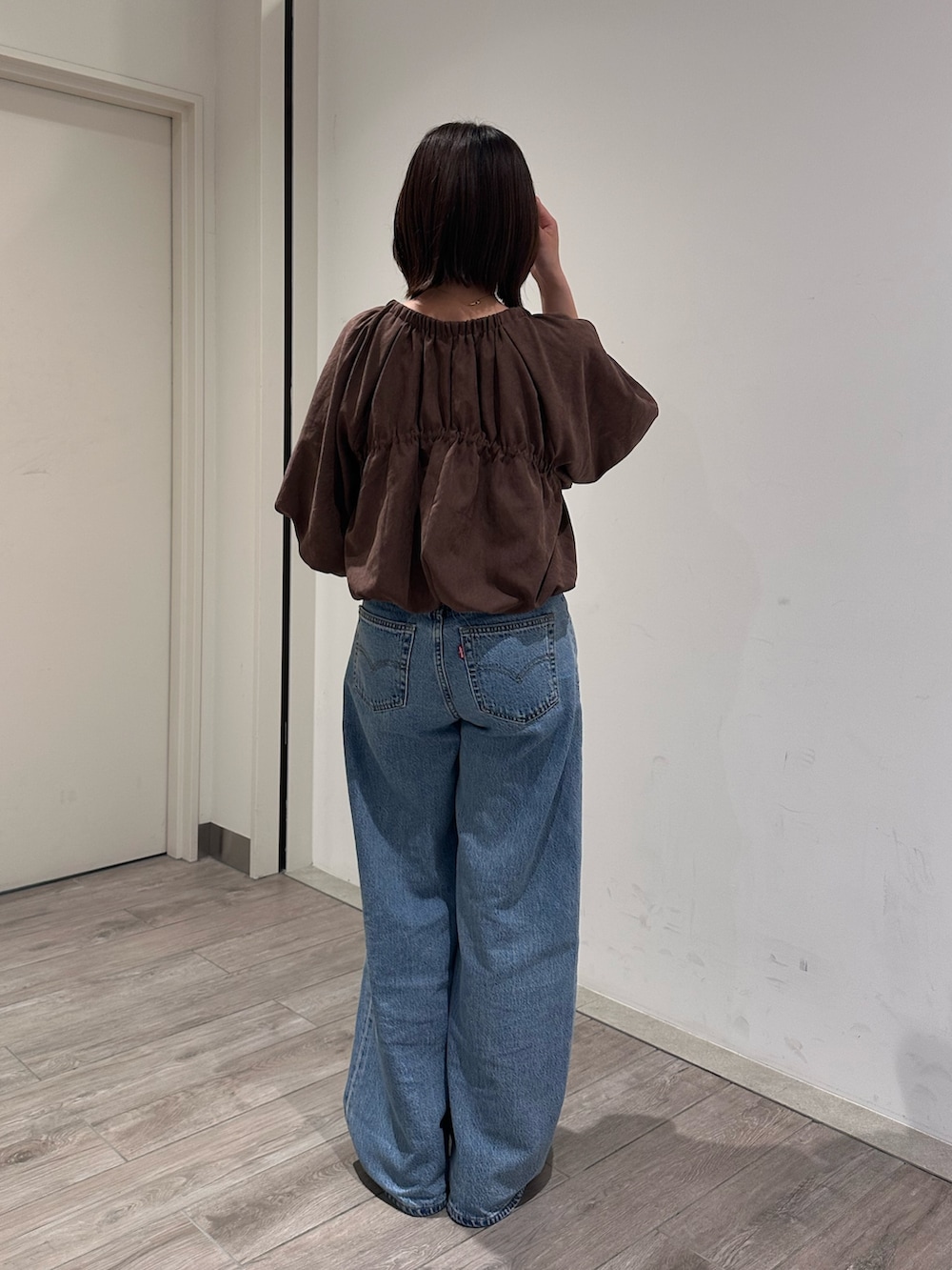 ブラウン系のシャツ/ブラウス、ブルー系のデニムパンツを着用したレディースの秋コーディネートの3枚目の写真